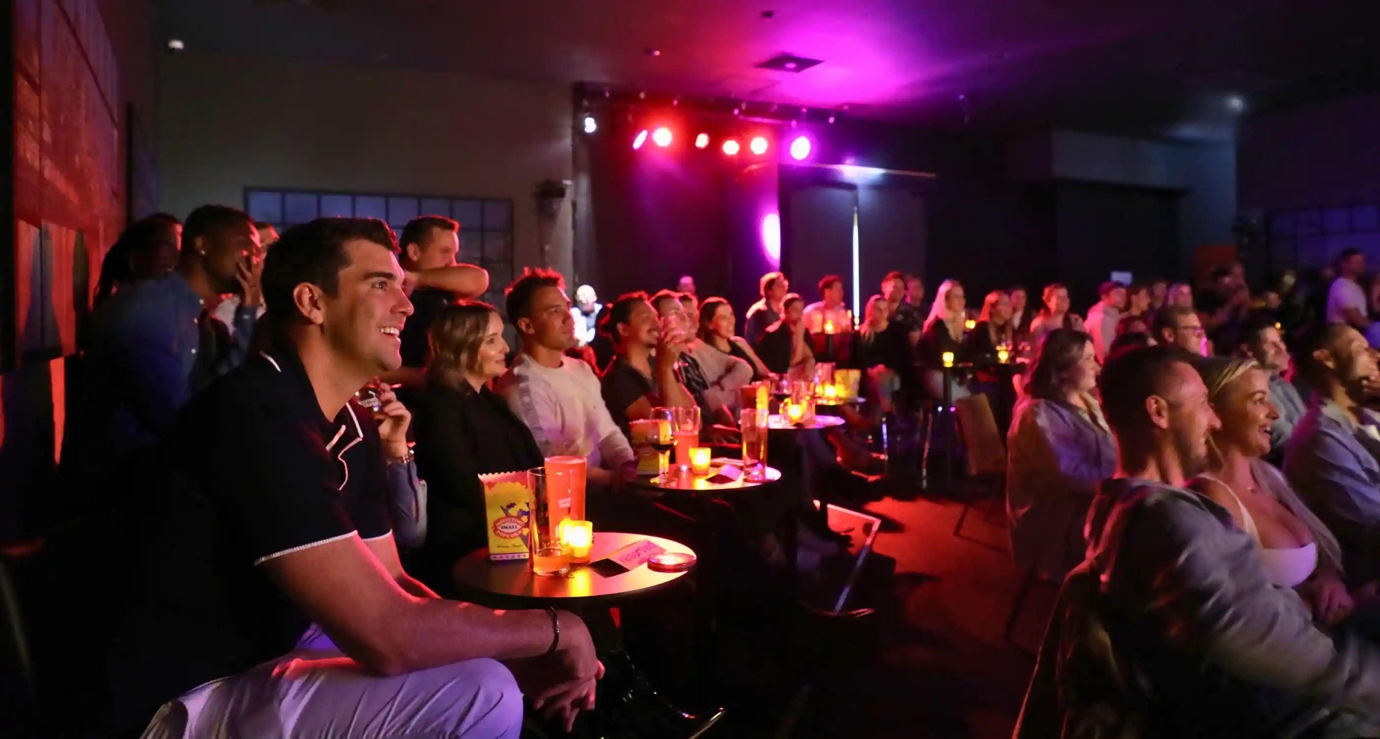 crowd laughing and drinking while they watch a live comedy show in perth western australia