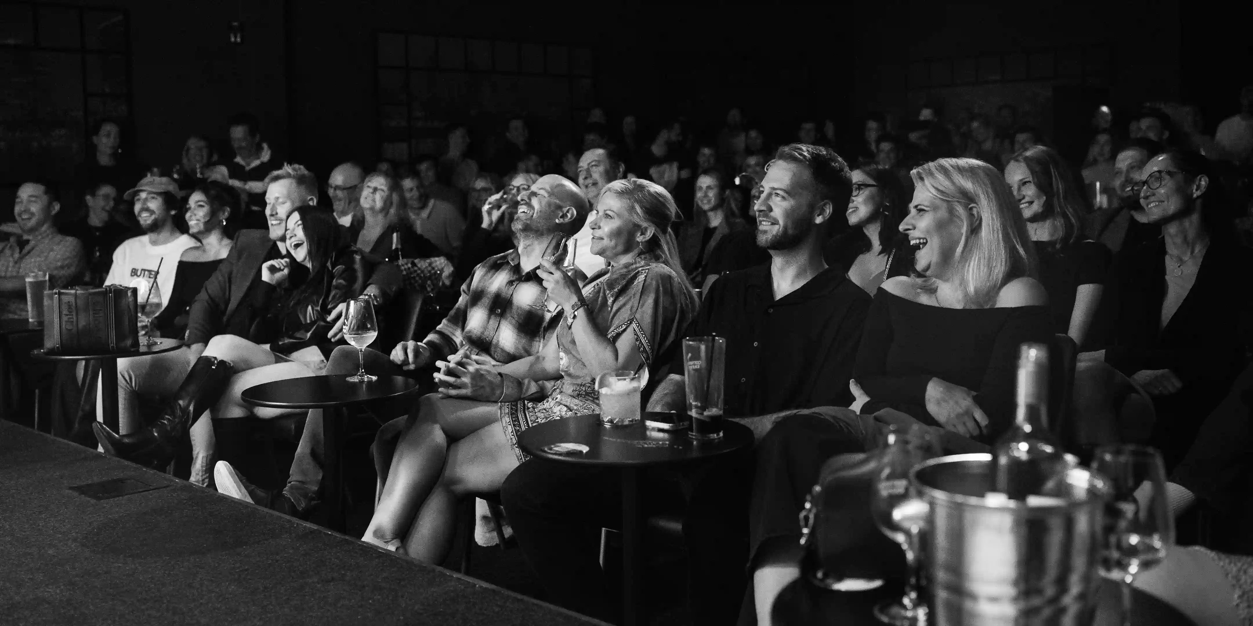 People laughing and enjoying a comedy show during a date night at Comedy Lounge Perth